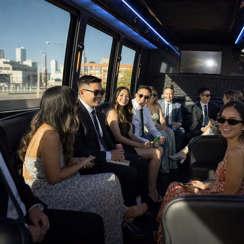 Wedding guests seated inside a Freemont party bus