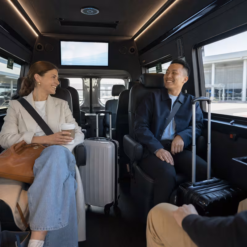 Passengers loading luggage while boarding an Freemont group shuttle