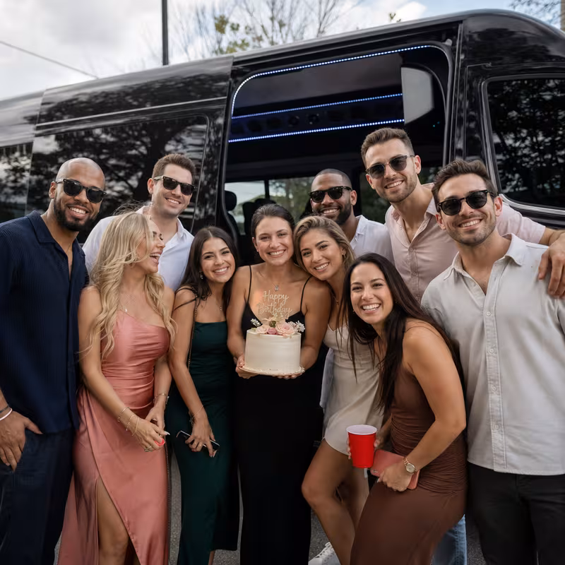 Group boarding a white charter bus for Birthday Transportation transportation in Freemont