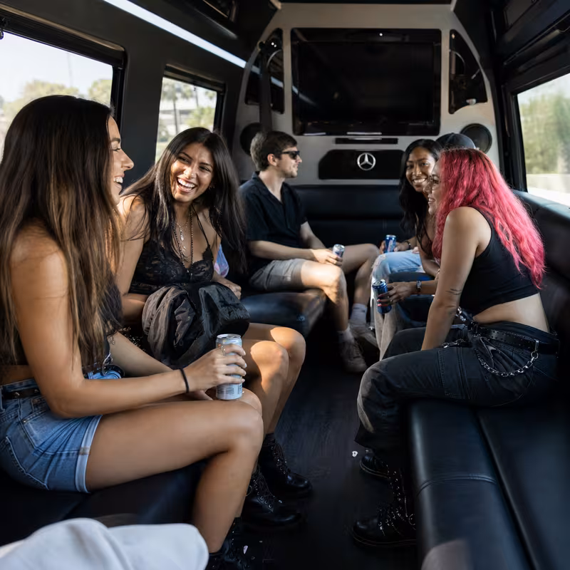 Group boarding a white charter bus for Concert Transportation transportation in Fremont