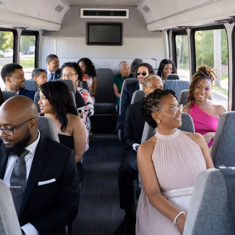 Group boarding a white charter bus for Private Event Transportation transportation in Freemont
