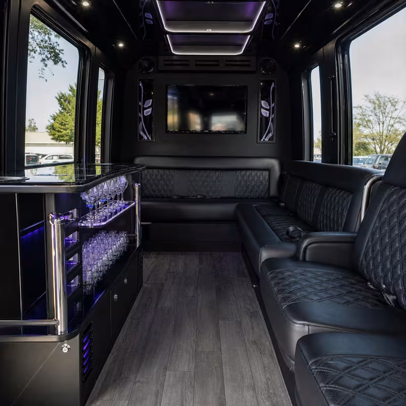 Party bus interior with wraparound leather seating and LED lighting in Freemont