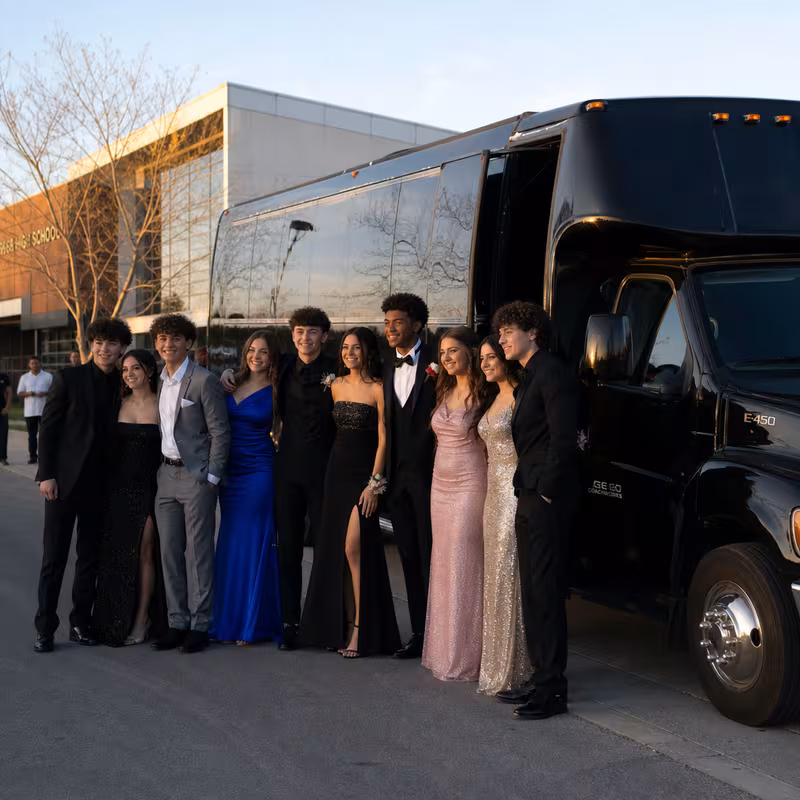 Group boarding a white charter bus for Prom & Homecoming Transportation transportation in Freemont
