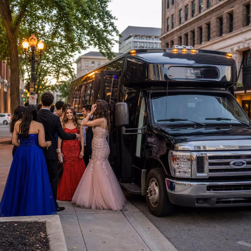 Passengers loading luggage while boarding an Freemont group shuttle