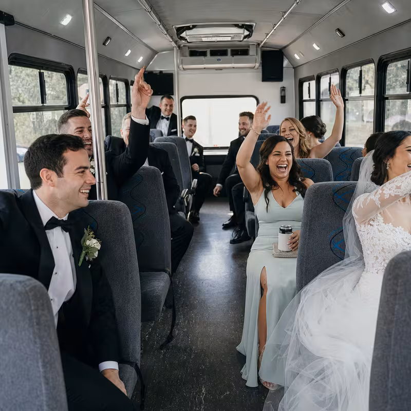 Group boarding a white charter bus for Wedding Transportation transportation in Freemont
