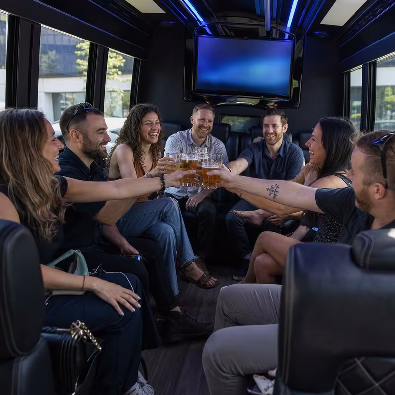 Group boarding a white charter bus for Winery & Brewery Tour Transportation transportation in Freemont