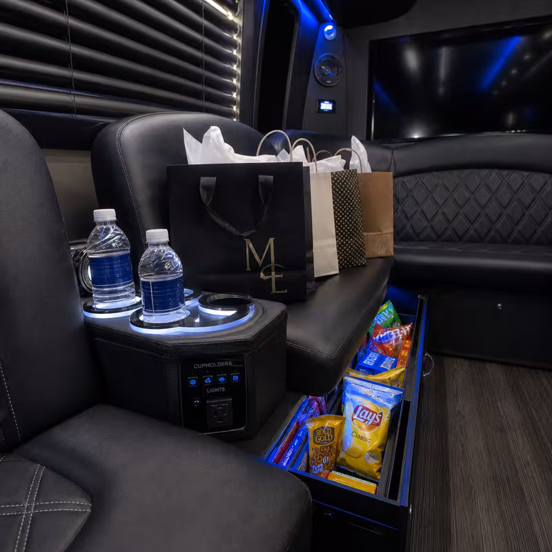 Party bus interior with wraparound leather seating and LED lighting in Freemont